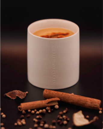 Essence candle in a ceramic jar, blending frankincense, clove, and warm oriental spices for a rich, indulgent aroma. There are spices splashed all over the table, the essence candle stands in the middle of this chaos but is not touched by it. Instead, it's grounded, firm, and strong.