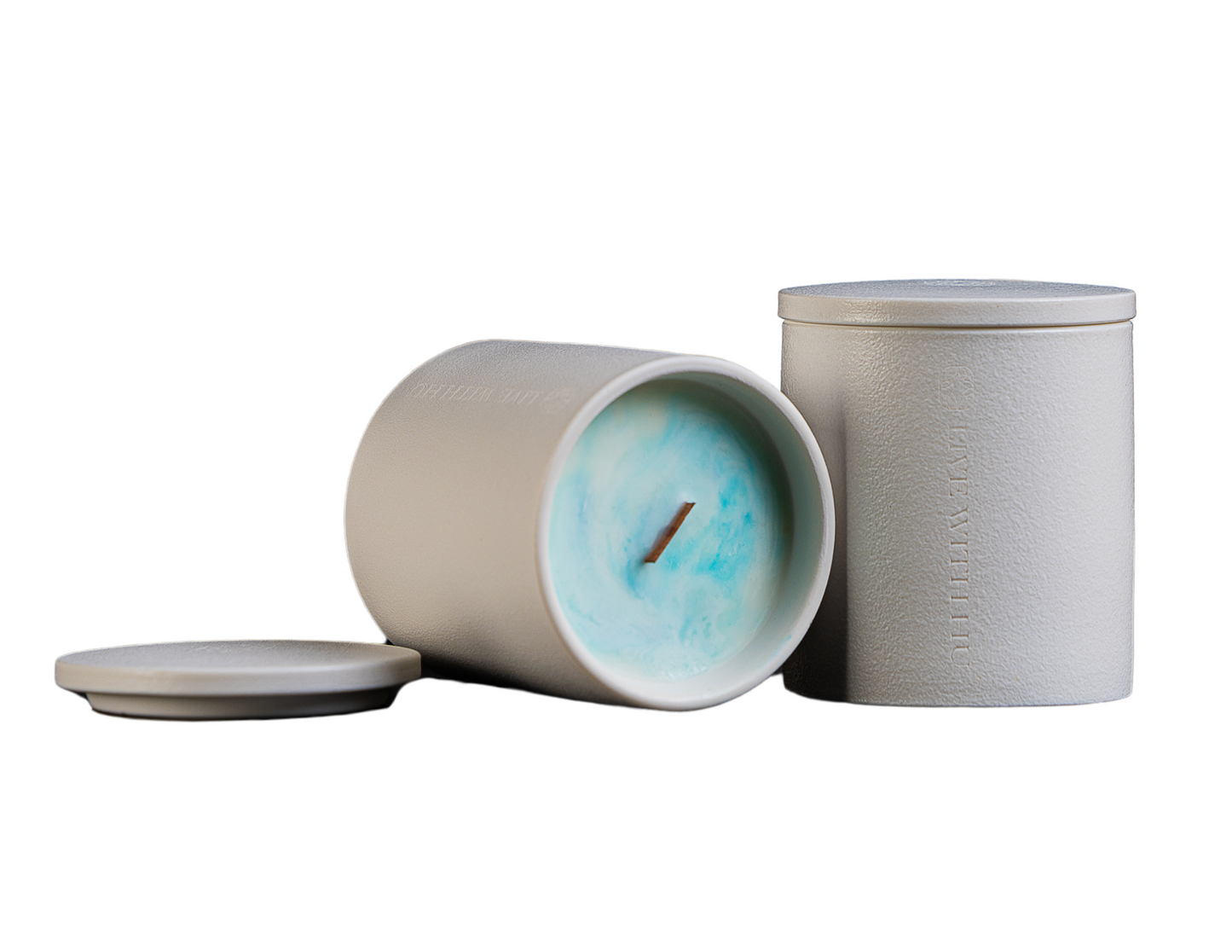 The grace candle in an elegant ceramic jar, showcasing not only the timeless vessel but also the colorful wax inside with an artistic pattern.