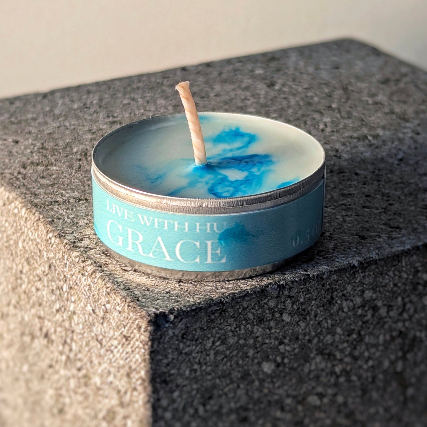 Single tealight candle in signature scent - grace. Fresh linen and Bergamot inspired.