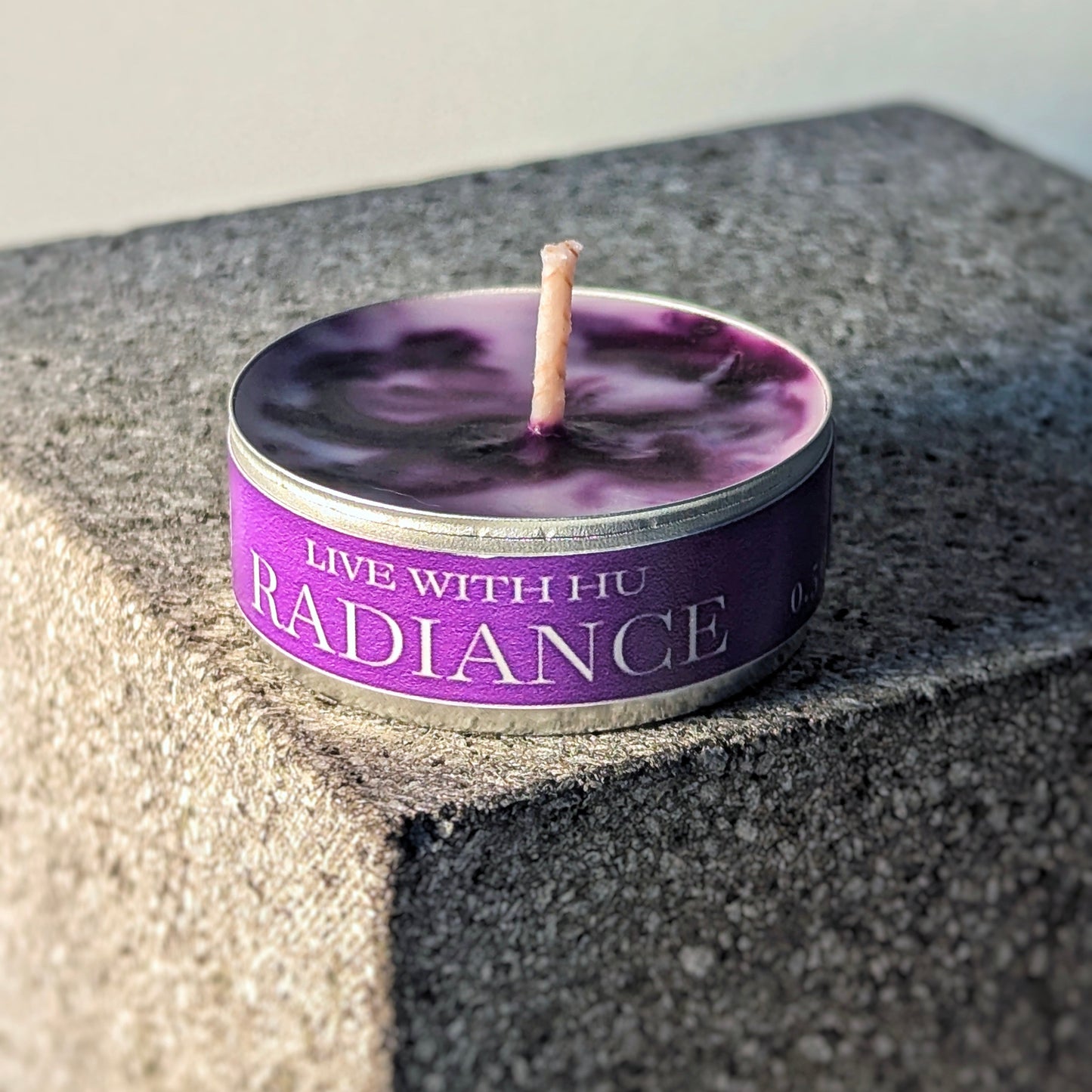 Single tealight candle in signature scent - radiance. Lilac and frankincense inspired.