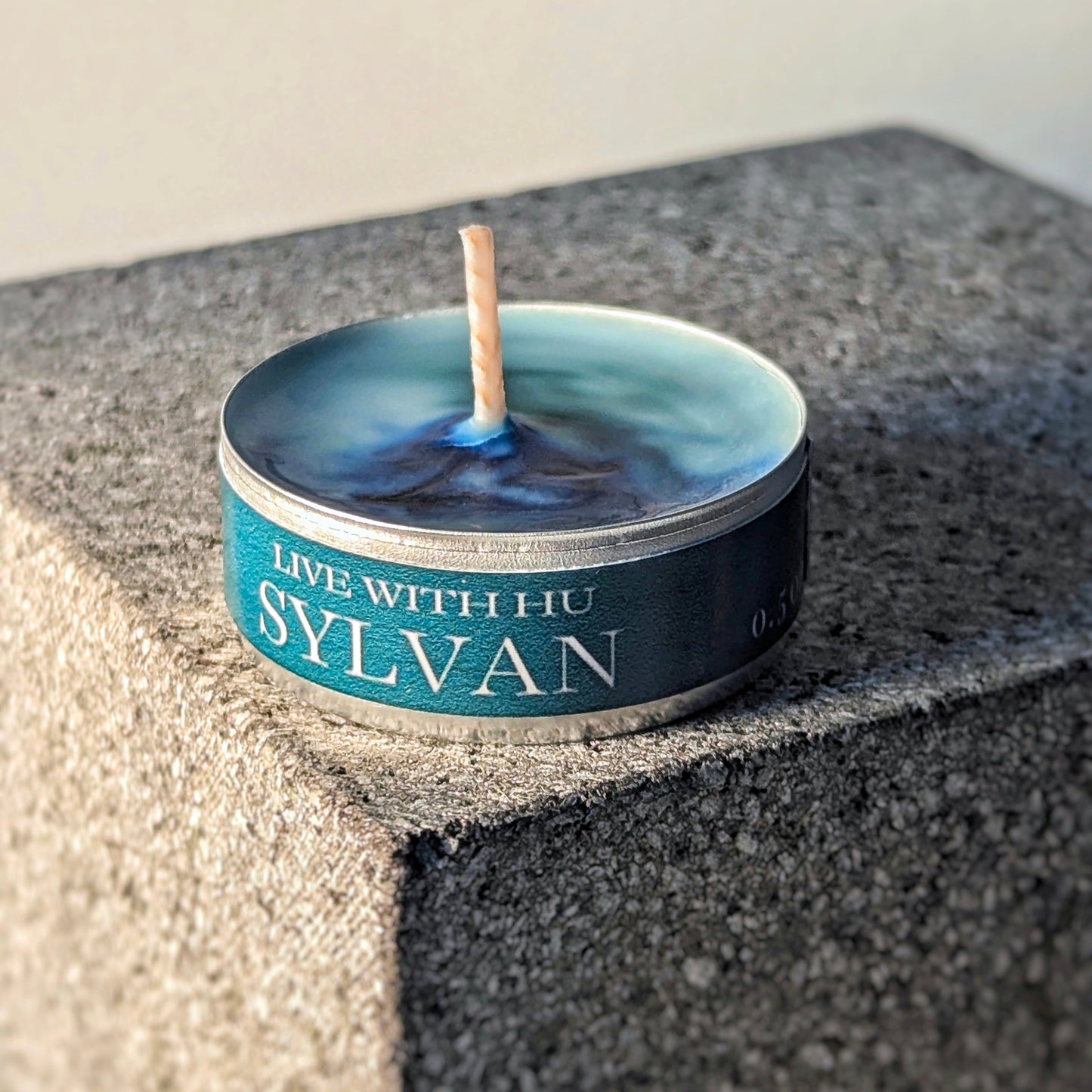 Single tealight candle in signature scent - sylvan. Rain forest and nature inspired.