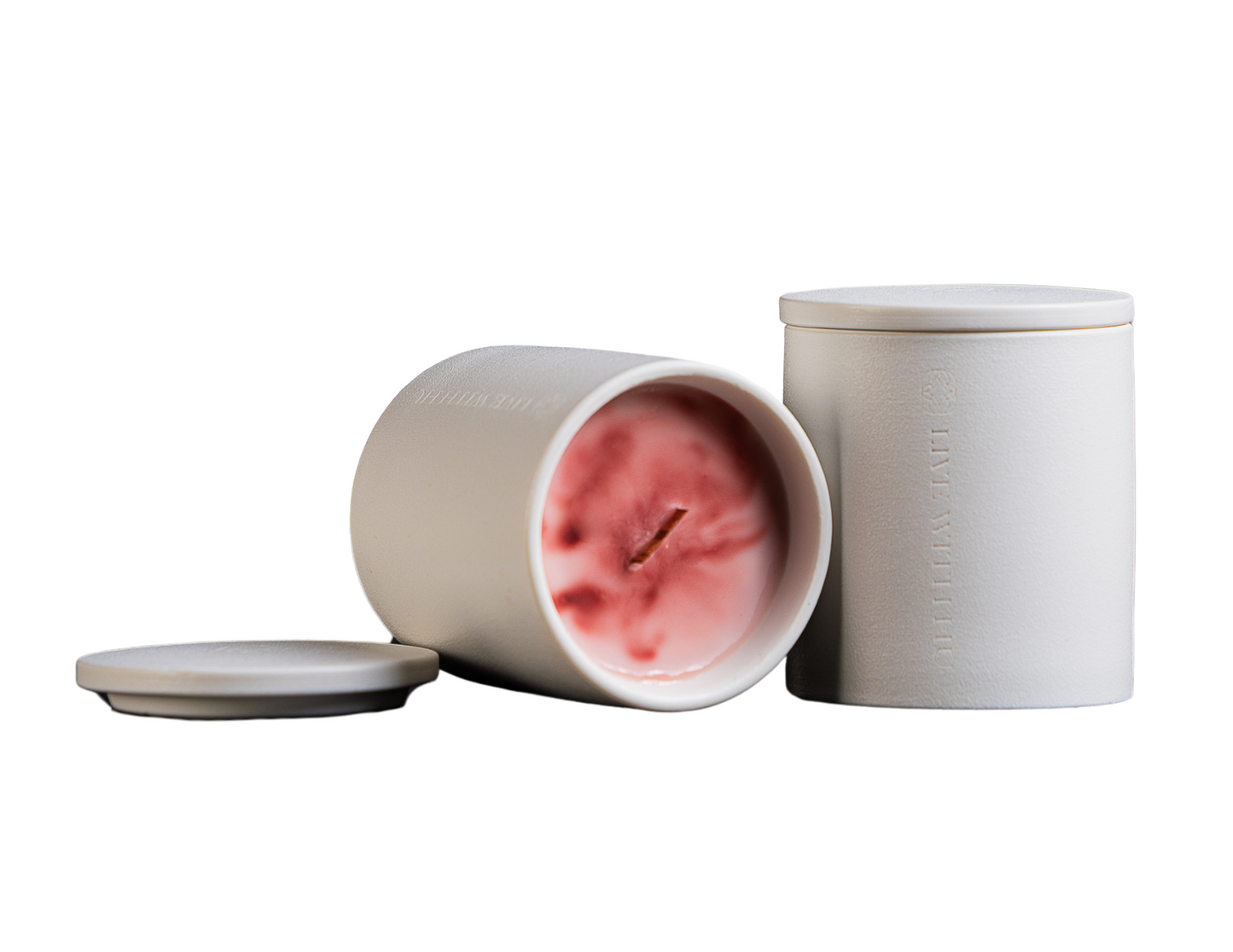 The blaze candle on white background. showcasing the luxury timeless ceramic vessel, as well as its beautifully blended rosy, red wax.