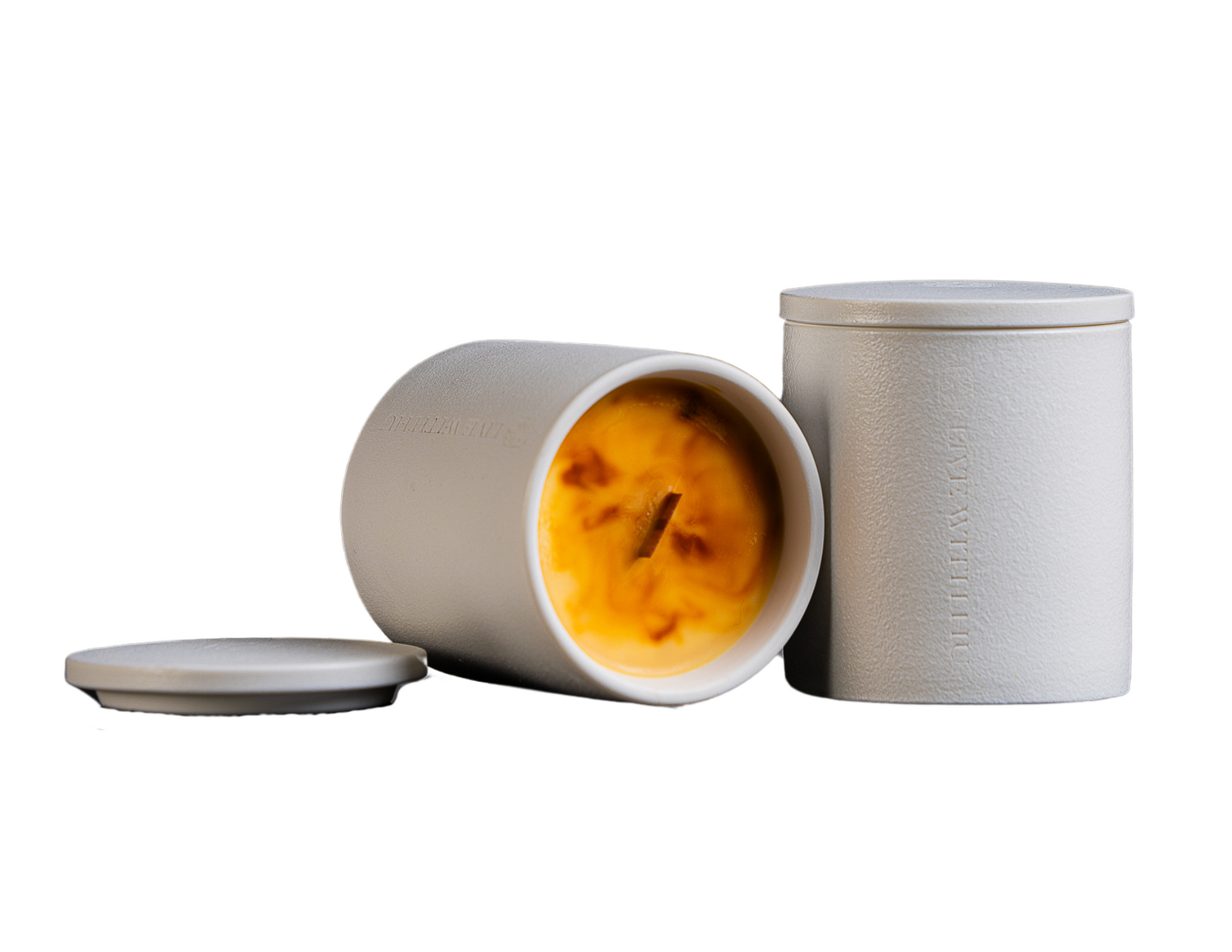 Essence candle in white background. This portrait showcases the timeless ceramic vessel, as well as the luxury wax blend that is aesthetically colored. 