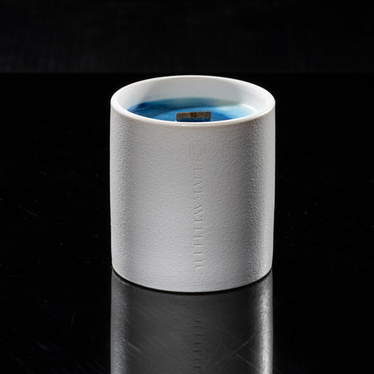 The elegant sylvan candle sitting in the dark, with its image reflection on the counter. Real power is quiet - this mixture of blue and green wax is not only toxin-free, but also demonstrate the calmness and peacefulness power it can bring to your heart.
